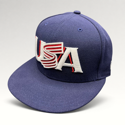 Raree Finds navy New Era 59FIFTY fitted hat with red and white USA Olympic embroidery and a structured flat brim.