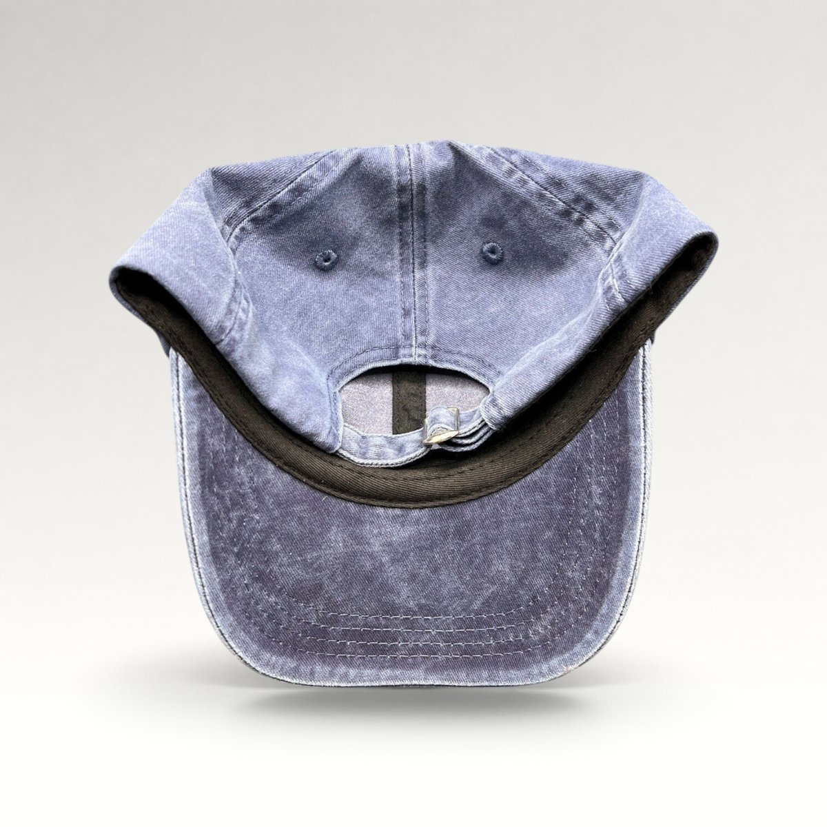 Raree Finds navy washed cotton dad hat with adjustable strap closure, showing the interior and back view.