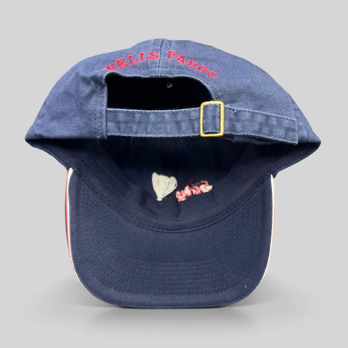 Raree Finds vintage navy blue Wells Fargo strapback golf hat with brass buckle and red rear embroidery