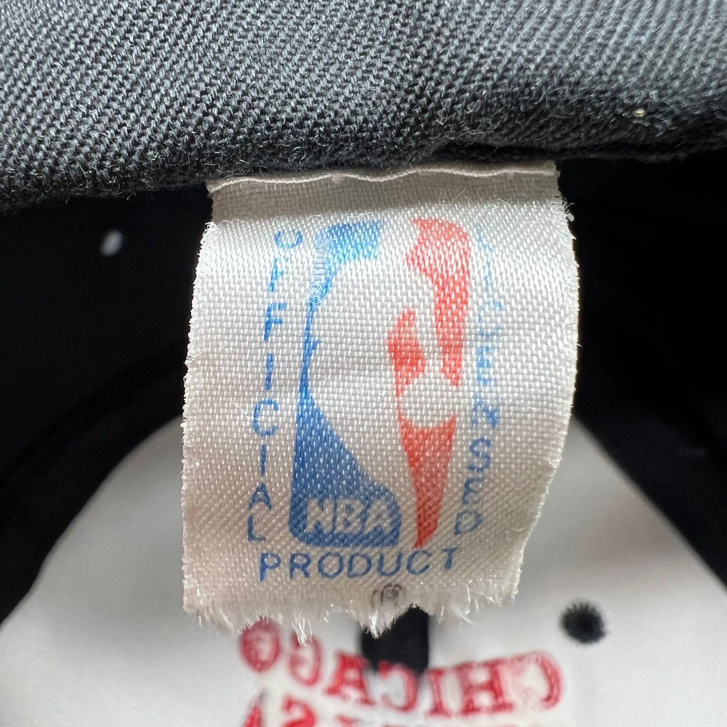 Raree Finds vintage 90s NBA official product tag on a Chicago Bulls snapback hat