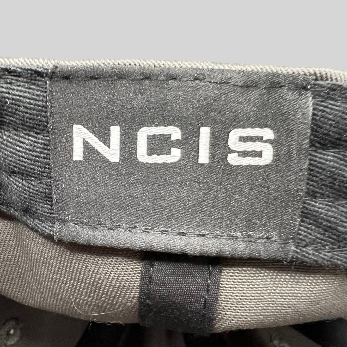 Raree Finds gray NCIS Cast & Crew strapback hat with white embroidered logo on the interior tag