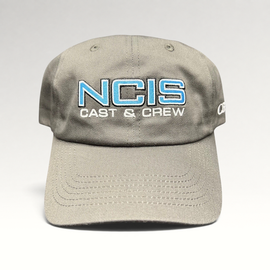 Raree Finds gray NCIS Cast & Crew strapback hat with blue and white embroidered logo on a curved bill cap