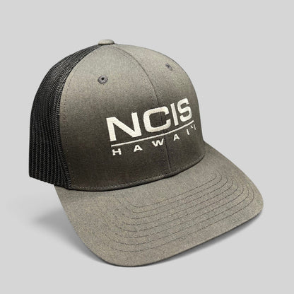 Raree Finds NCIS Hawaii film crew trucker hat with gray structured crown, black mesh back, and white front embroidery.