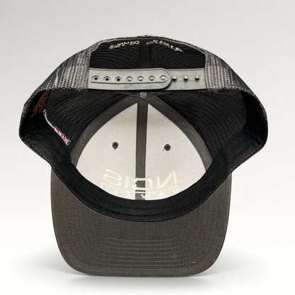 Raree Finds NCIS Hawaii film crew trucker hat with gray structured crown, black mesh back, and adjustable snapback.