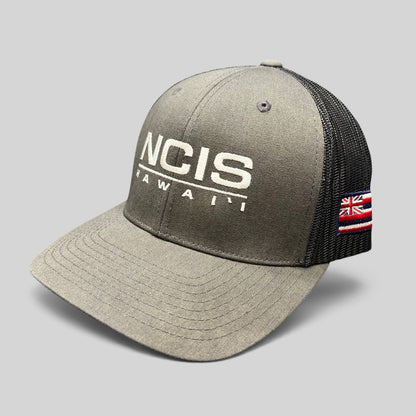Raree Finds NCIS Hawaii trucker hat with gray structured crown, black mesh back, and white embroidered front logo.