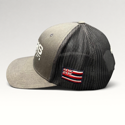 Raree Finds NCIS Hawaii trucker hat in gray and black with white embroidery and a side Hawaii state flag patch