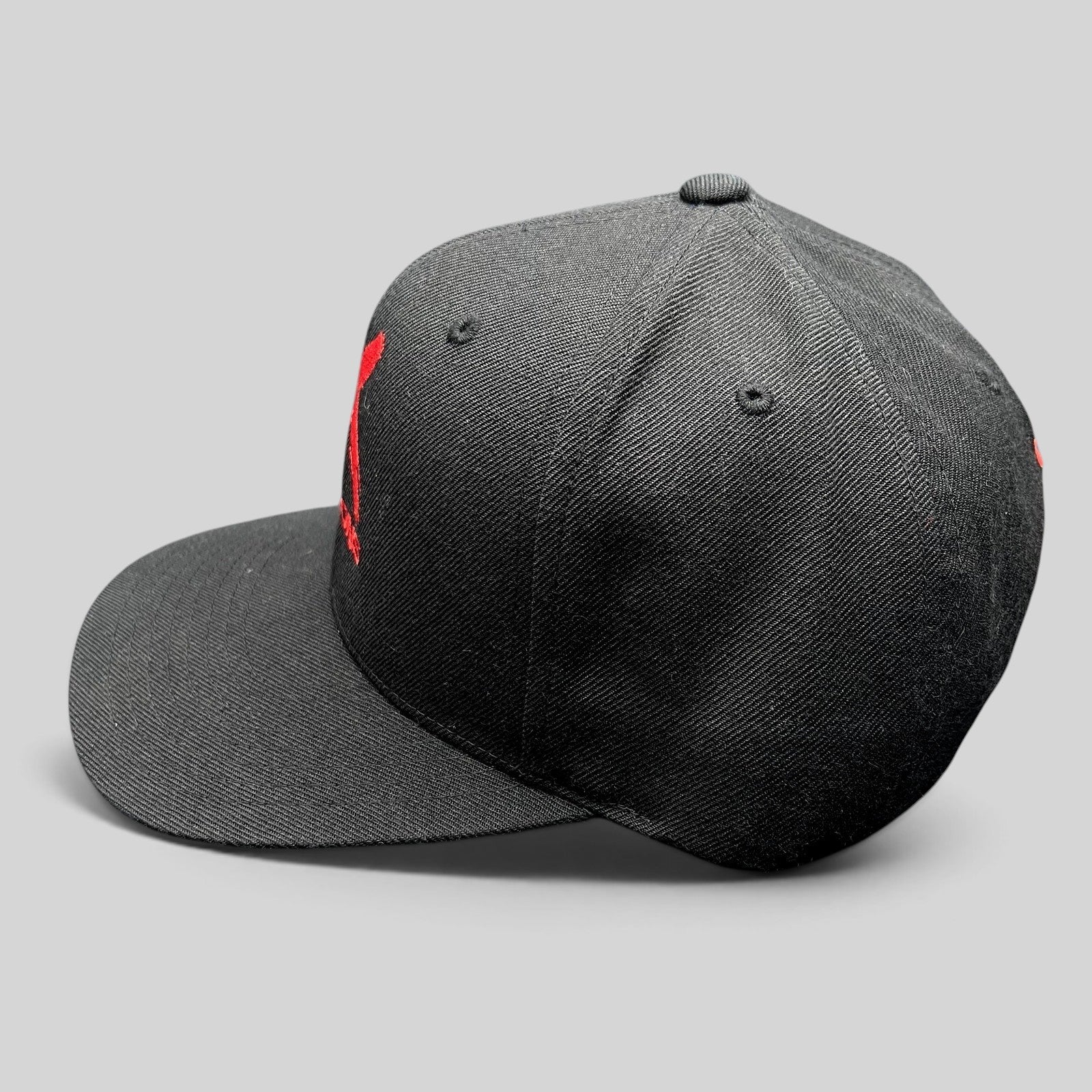 Raree Finds black NCIS Los Angeles X Seasons snapback hat with red embroidered logo and structured crown