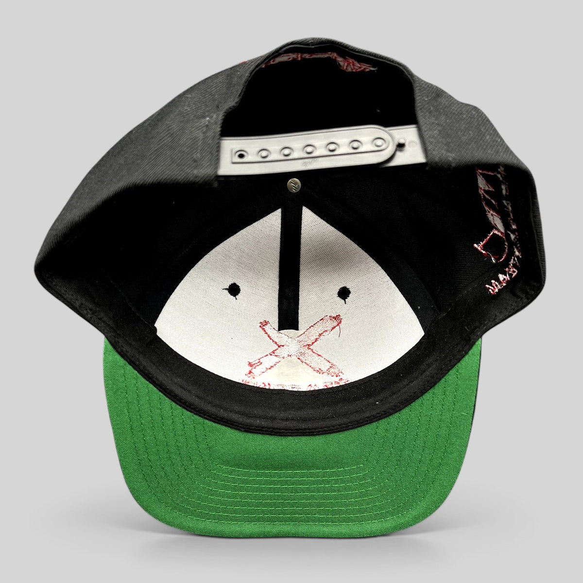 Raree Finds NCIS Los Angeles X Seasons snapback hat with black crown, green undervisor, and adjustable snap closure.