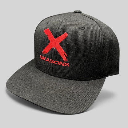 Raree Finds NCIS Los Angeles X Seasons black snapback hat with distressed red embroidered logo and green undervisor.