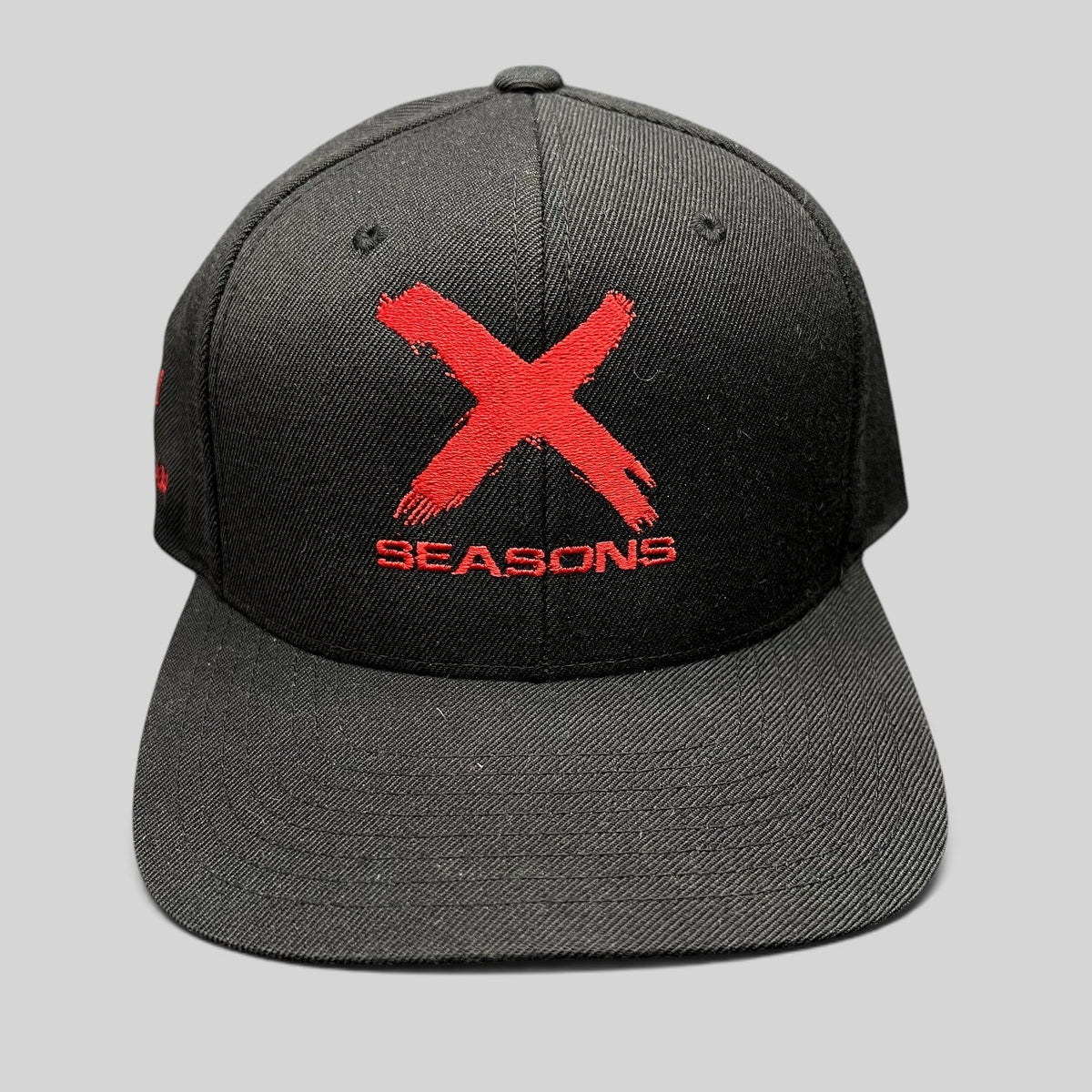Raree Finds NCIS Los Angeles X Seasons black snapback hat with distressed red embroidered logo and green undervisor