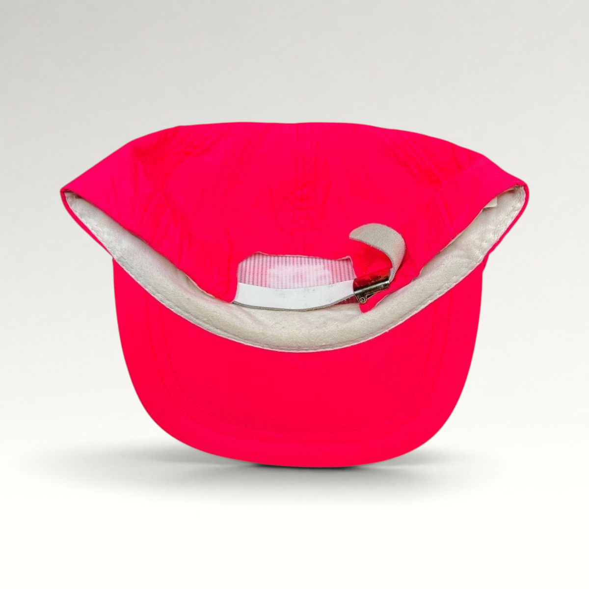 Raree Finds vintage 80s neon pink nylon ski hat showing the interior foam sweatband and adjustable metal clasp