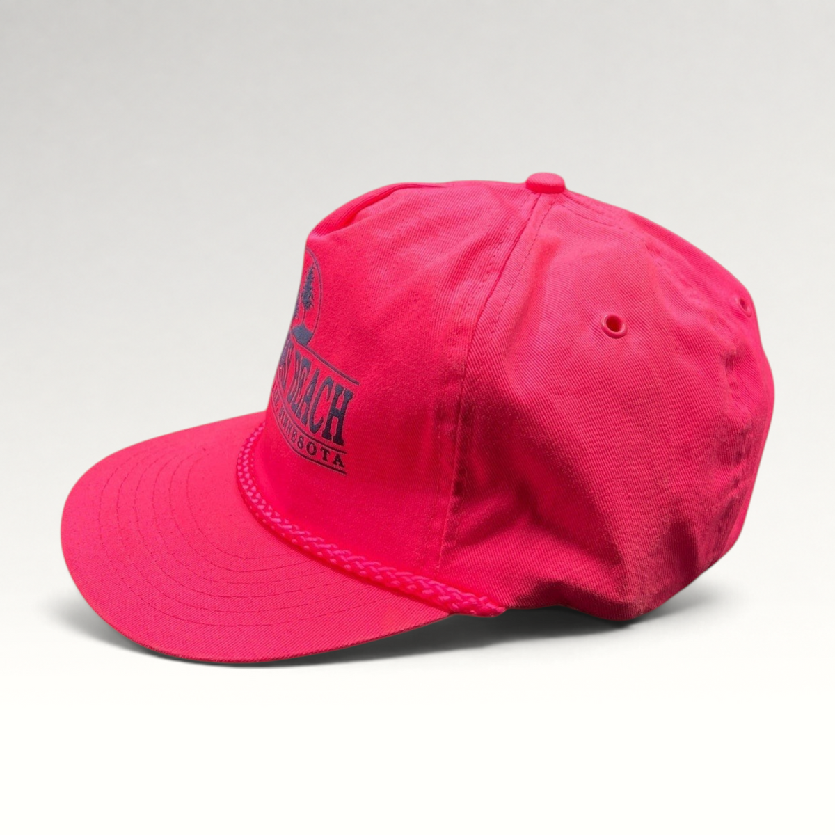 Raree Finds vintage 1980s neon pink snapback hat with navy Norway Beach graphic and decorative front braided rope