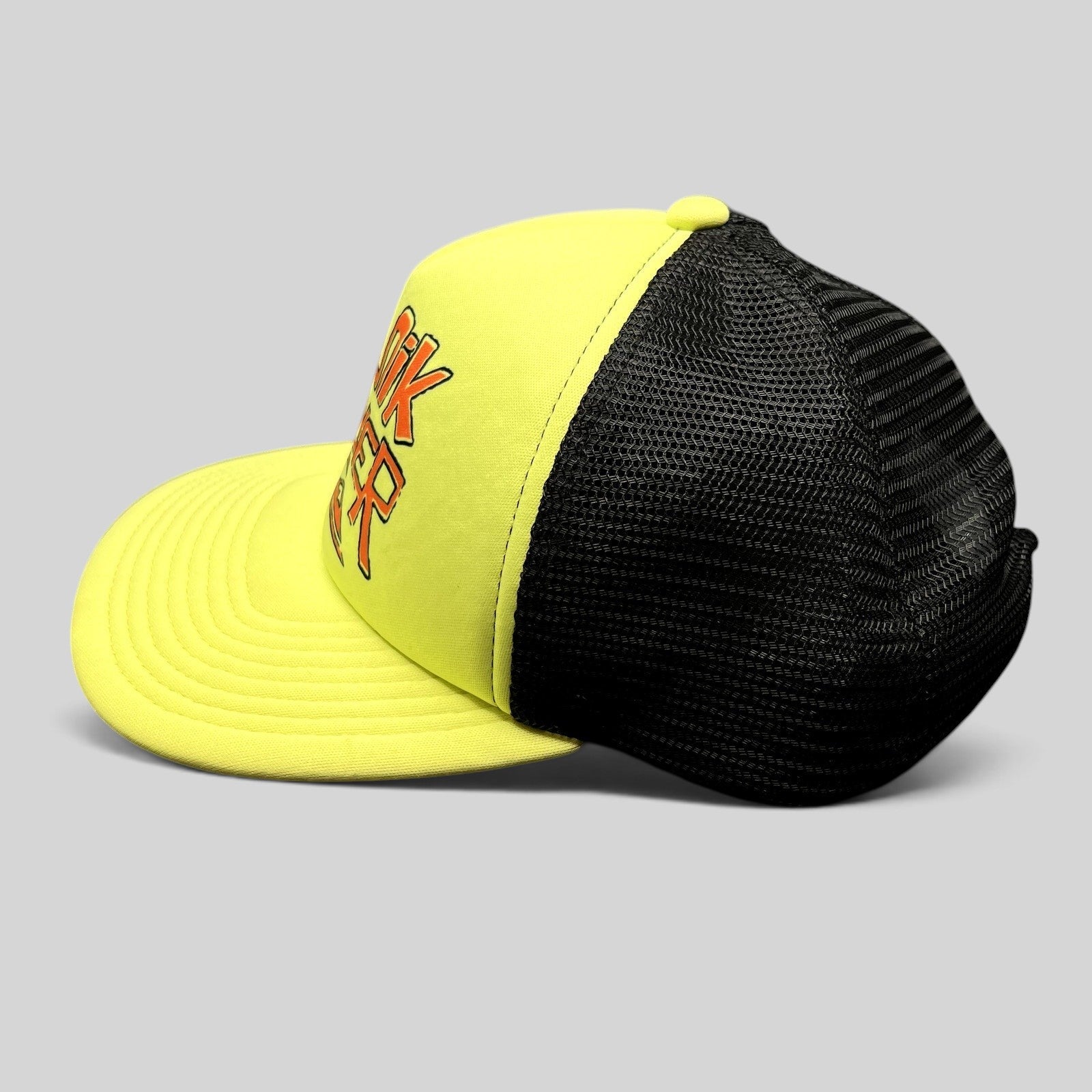 Raree Finds neon yellow and black Quiksilver trucker hat with mesh back and embroidered logo, side profile view.
