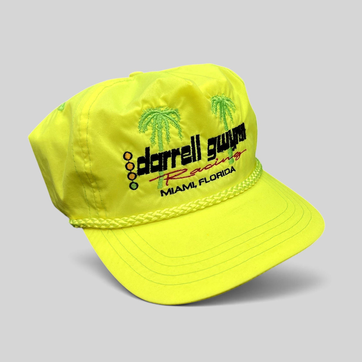 Raree Finds vintage neon yellow nylon Darrell Gwynn Racing snapback hat with embroidered palm trees and braided rope.