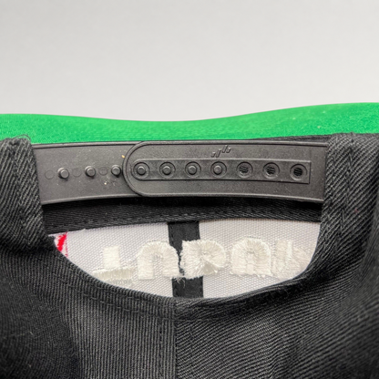Raree Finds Netflix Tudum snapback hat showing the adjustable black plastic snap closure and green undervisor detail.