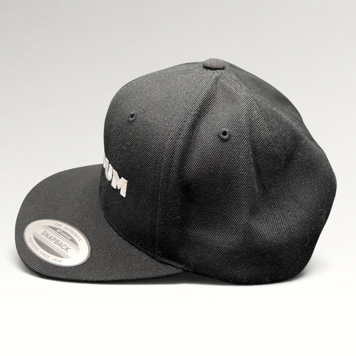 Raree Finds black Netflix Tudum snapback hat with white embroidered lettering and Yupoong flat brim design