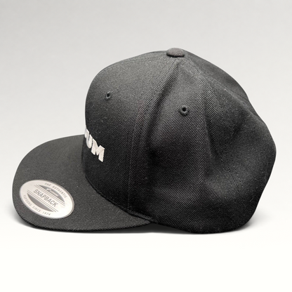 Raree Finds black Netflix Tudum snapback hat with white embroidered lettering and Yupoong flat brim design