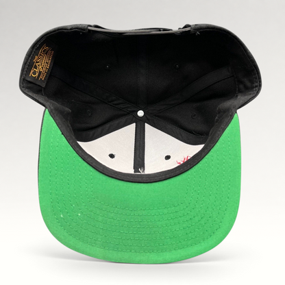 Raree Finds Netflix Tudum snapback hat showing the interior construction, green undervisor, and Yupoong Classics label.