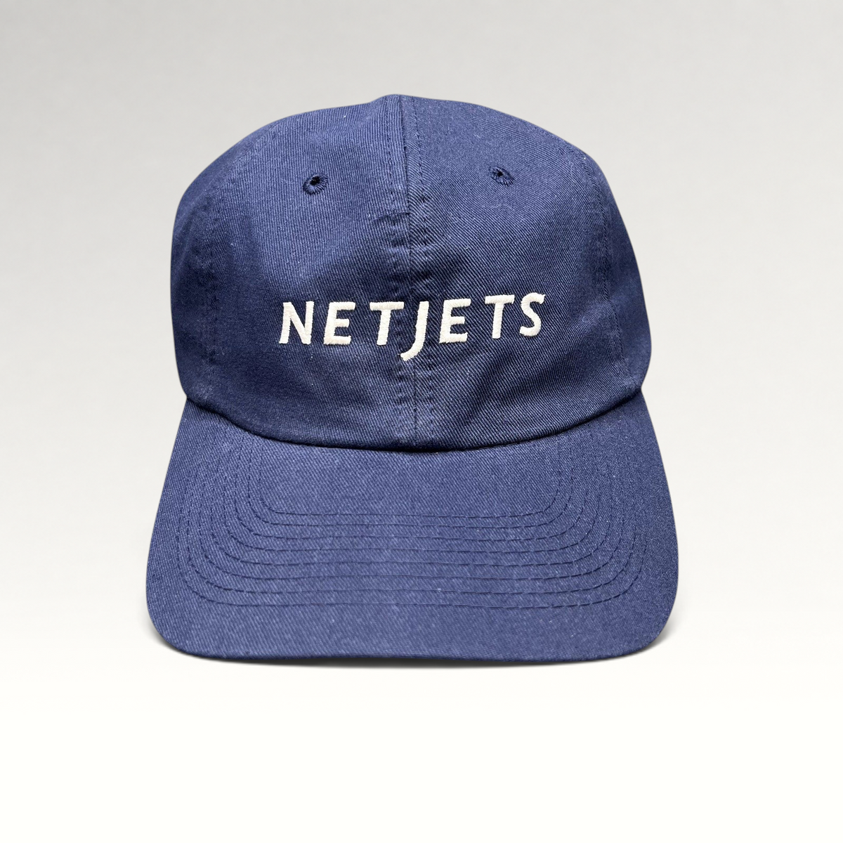 Raree Finds navy blue cotton strapback cap with white embroidered NetJets logo on the front