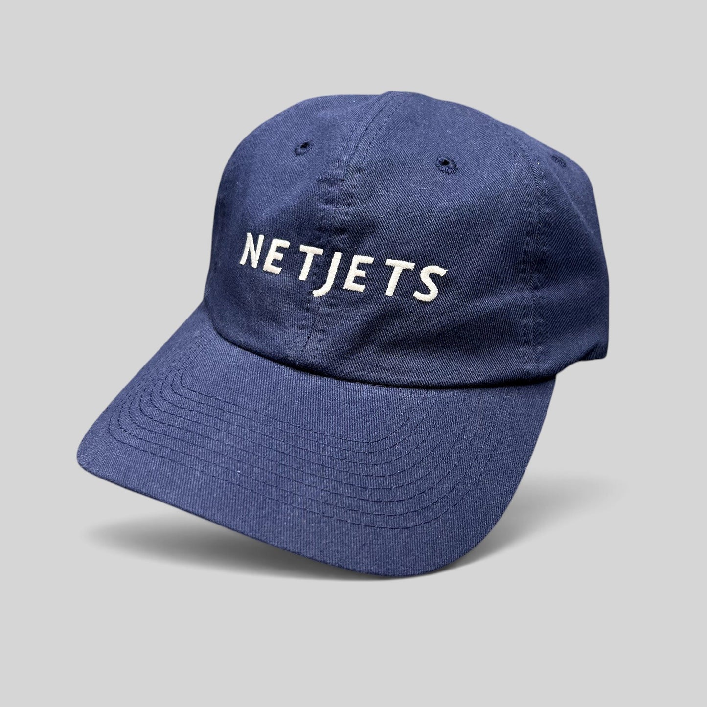 Raree Finds navy blue cotton strapback hat with white embroidered NetJets logo on the front