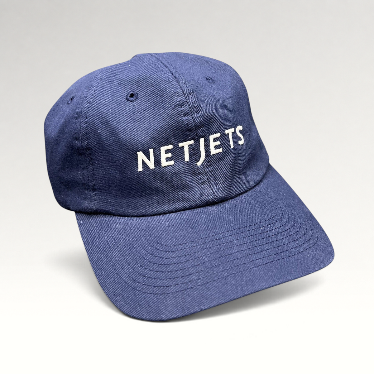 Raree Finds navy blue cotton NetJets strapback hat with white embroidered logo and adjustable leather strap