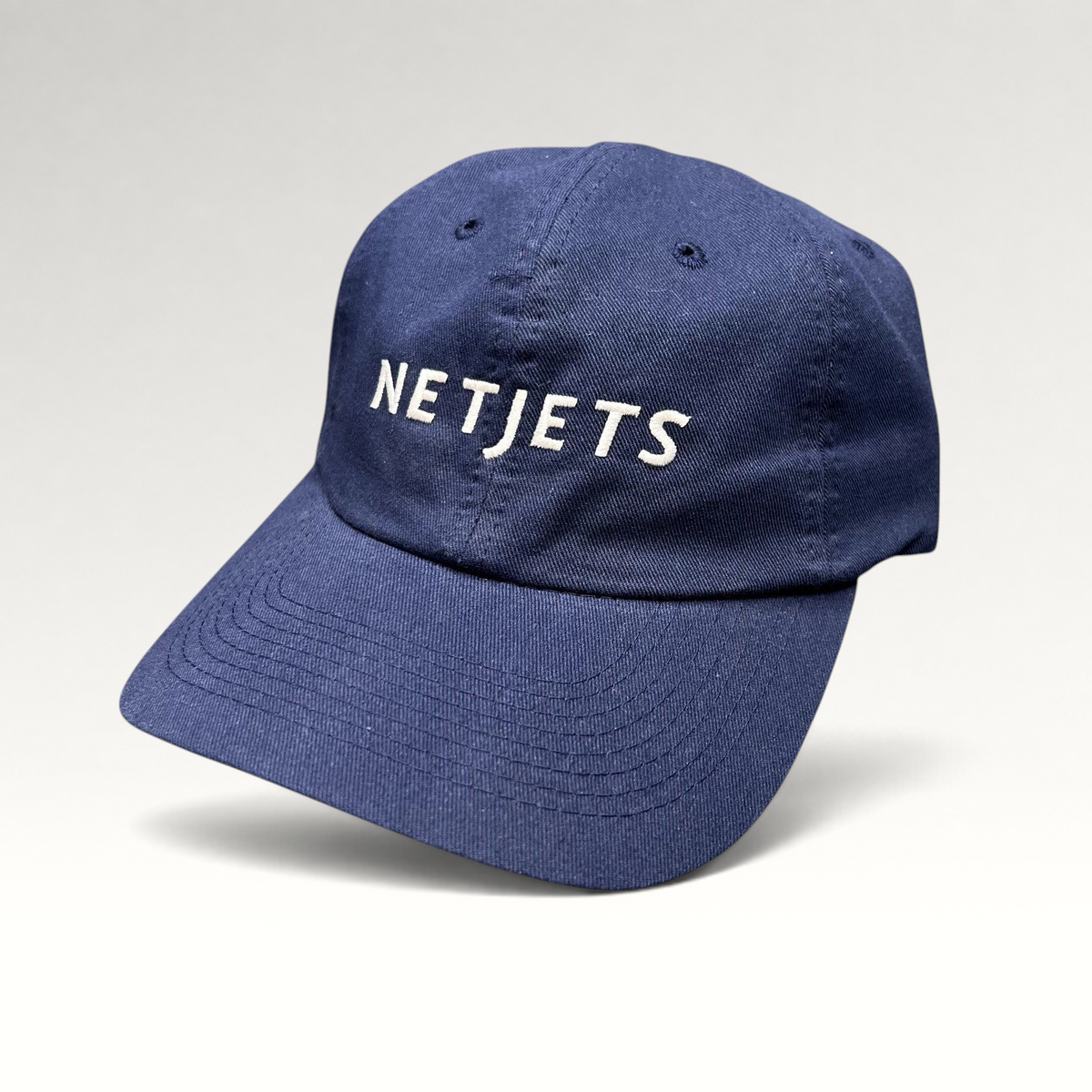 Raree Finds navy blue cotton strapback hat with white embroidered NetJets logo on the front