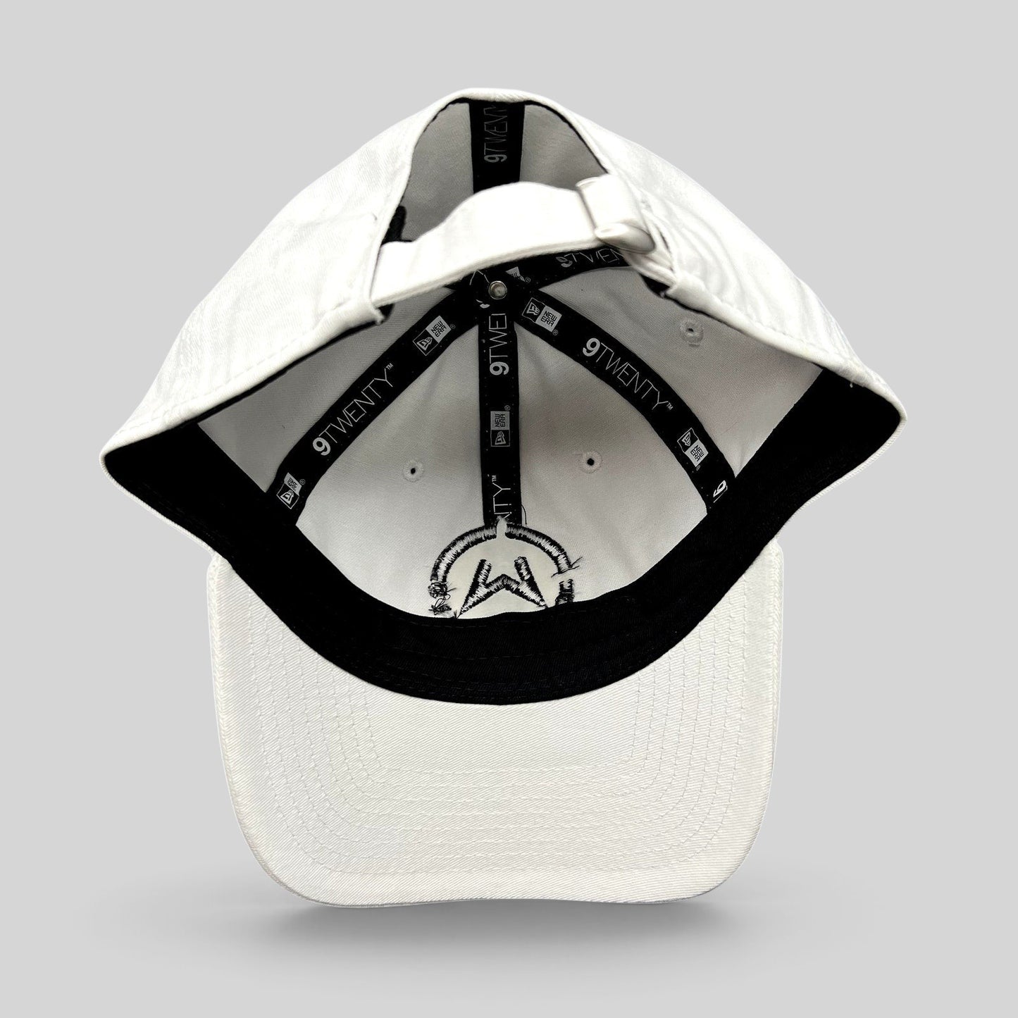 Raree Finds white New Era 9TWENTY dad cap interior view showing branded taping and black embroidered music logo