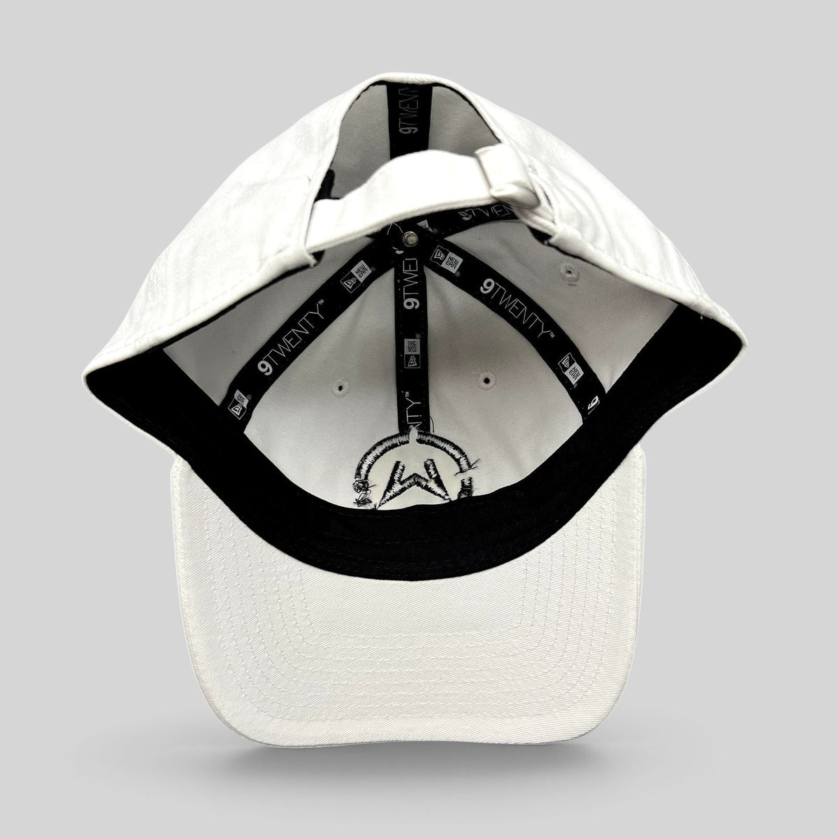 Raree Finds white New Era 9TWENTY dad cap interior view showing branded taping and black embroidered music logo