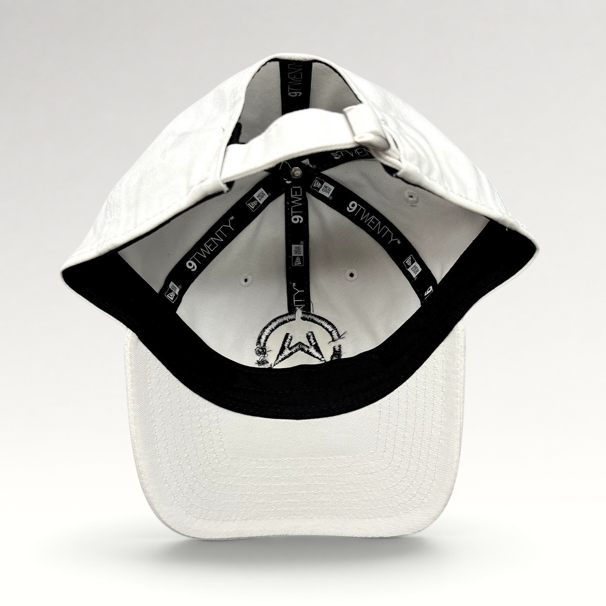 Raree Finds white New Era 9TWENTY dad cap interior view showing branded taping and black embroidered music logo