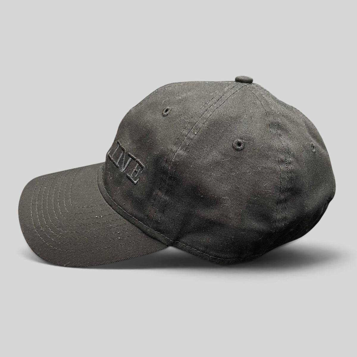 Raree Finds New Era 9TWENTY black cotton strapback hat with tonal DEADLINE embroidery and curved brim side view