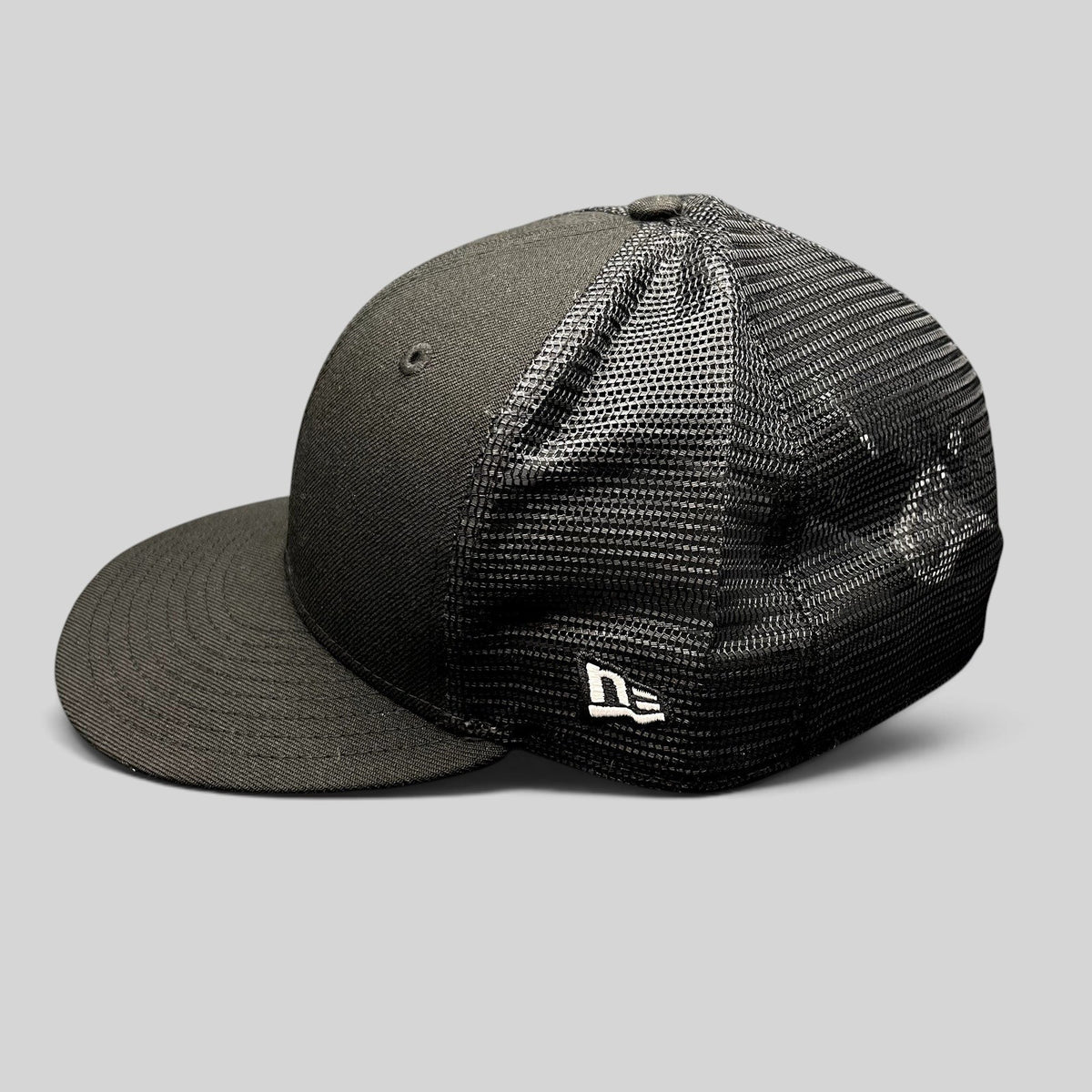 Raree Finds New Era 59FIFTY blank black fitted trucker hat with a structured high crown and breathable mesh back.