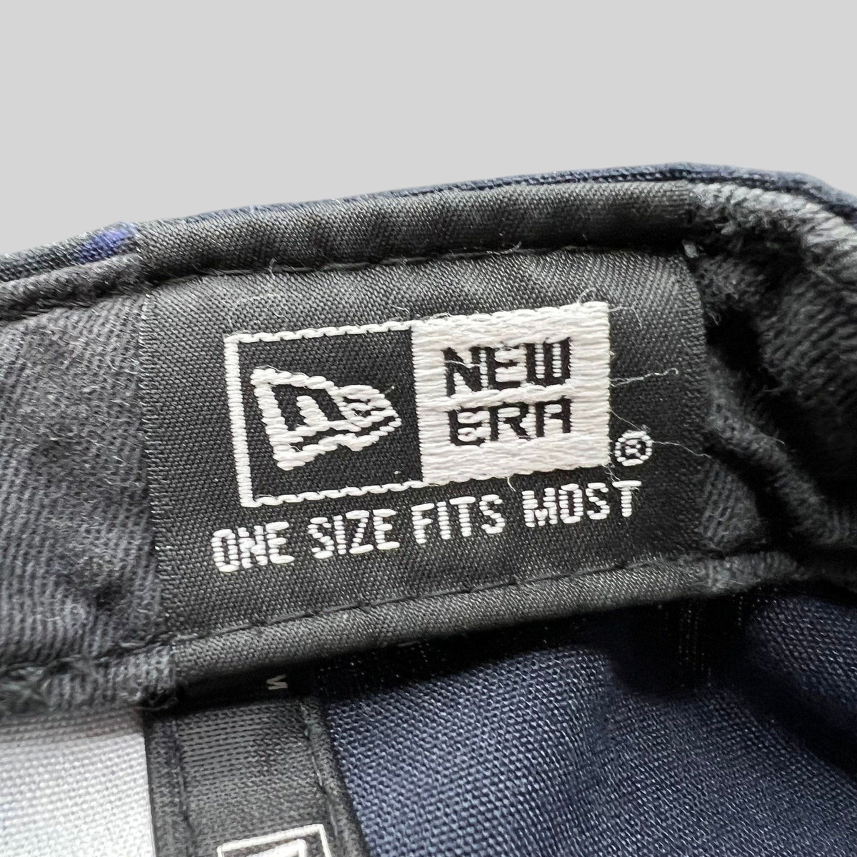 Raree Finds New Era 9FORTY cap interior label showing brand logo and one size fits most text on navy fabric