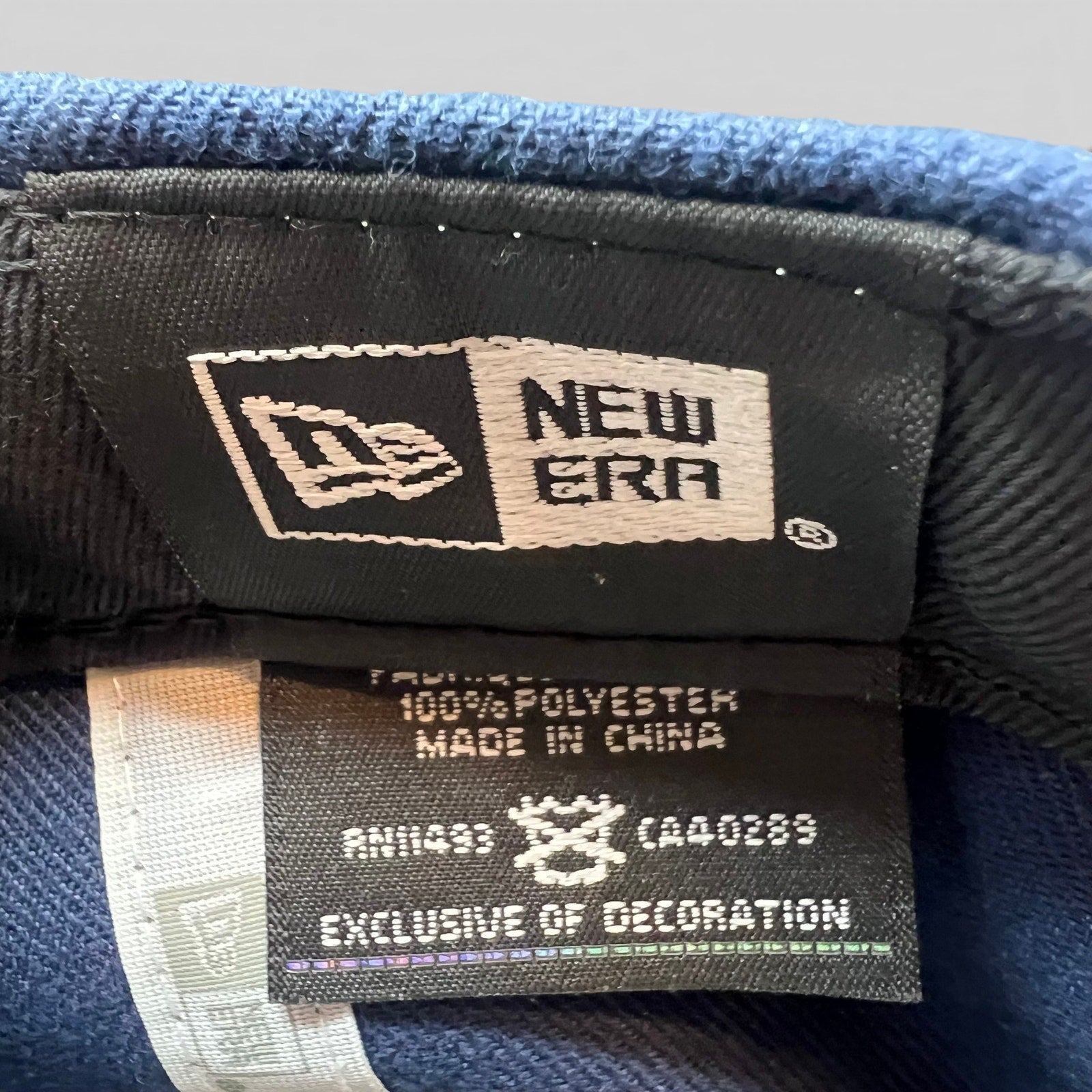 Raree Finds New Era snapback interior label showing 100% polyester material and manufacturing details