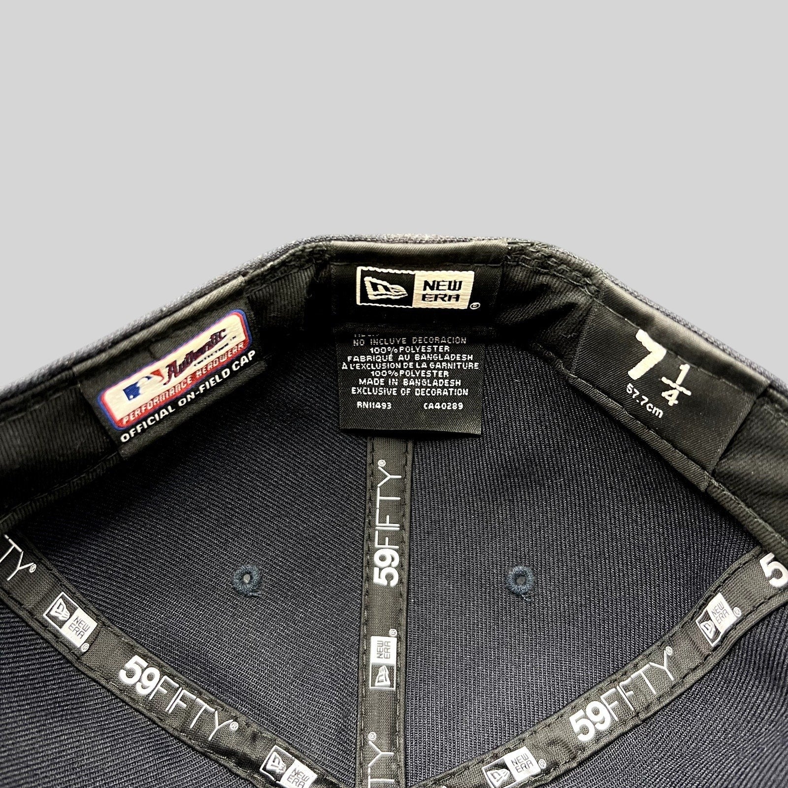 Interior of a Raree Finds New Era 59FIFTY fitted hat showing size 7 1/4 label and official performance taping