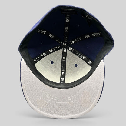 Interior view of a Raree Finds New Era 59FIFTY navy fitted hat showing branded taping and size 7 1/4 label.