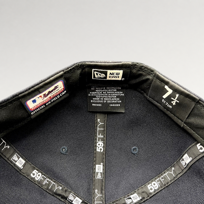 Interior of a Raree Finds New Era 59FIFTY fitted hat showing size 7 1/4 label and official performance taping