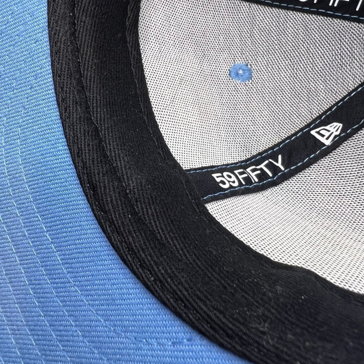 Raree Finds New Era 59FIFTY fitted hat interior showing black sweatband, logo tape, and light blue crown lining