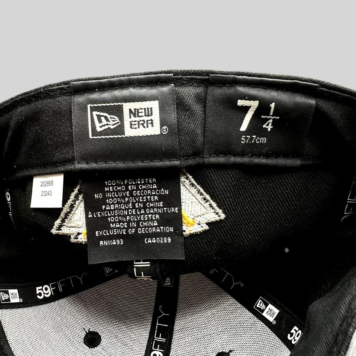 Raree Finds New Era 59FIFTY fitted hat interior tag showing size 7 1/4 and 100% polyester material details