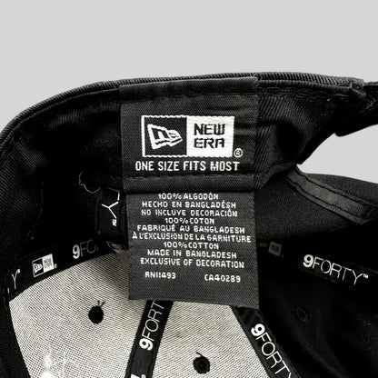 Raree Finds black New Era 9FORTY hat interior showing cotton care label and branding tags
