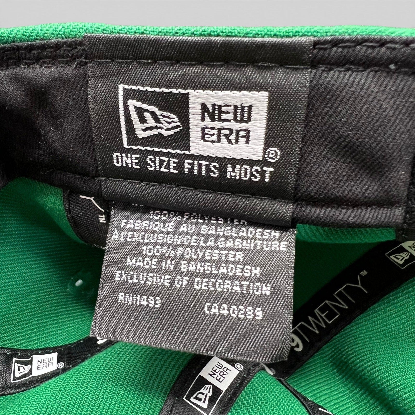 Raree Finds New Era 9TWENTY green hat interior showing the brand label and polyester fabric care tag