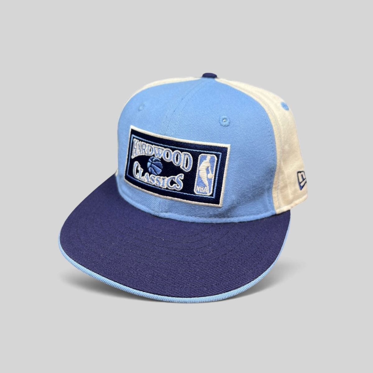 Raree Finds New Era 59FIFTY Hardwood Classics NBA fitted hat in light blue, navy, and cream with front embroidery.