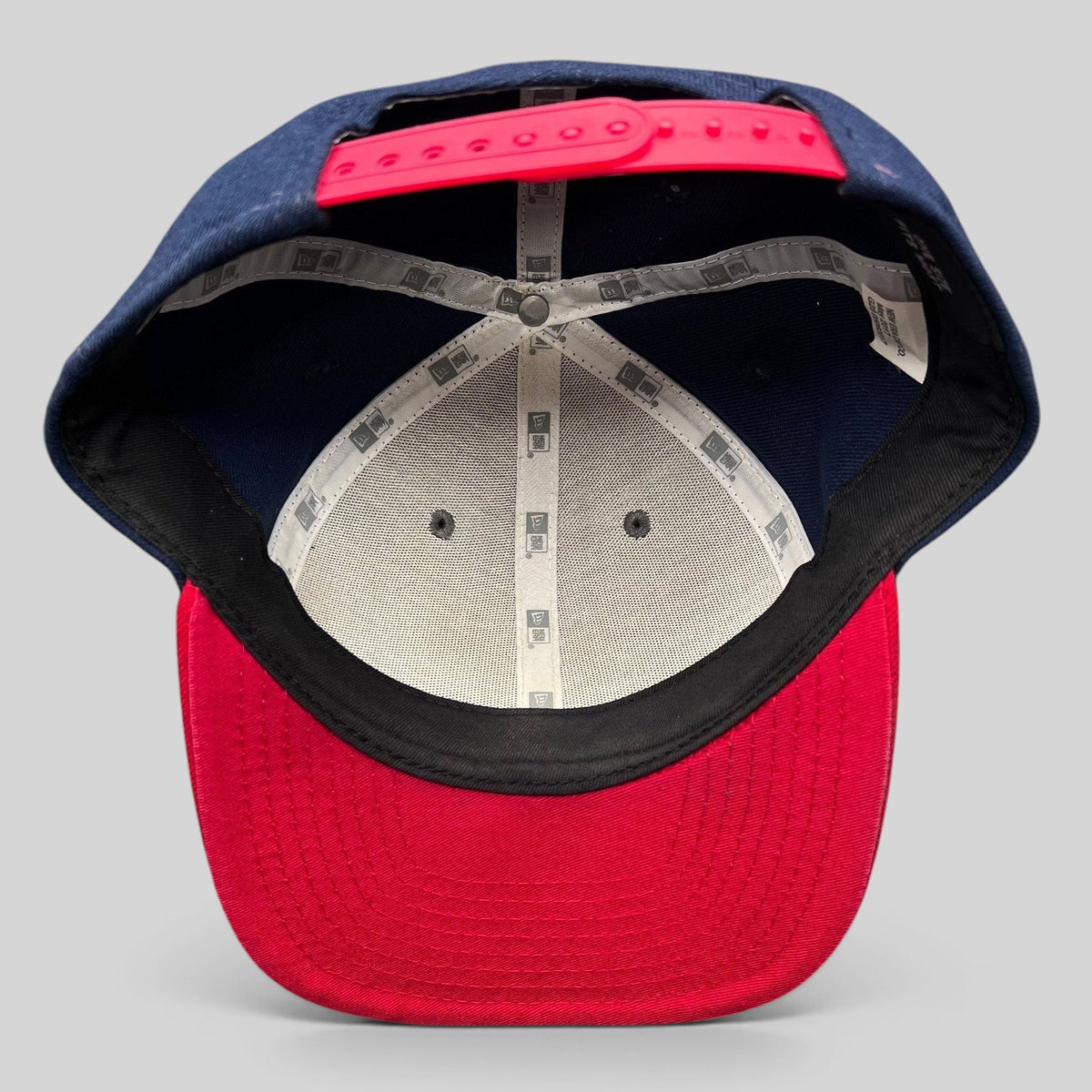 Raree Finds New Era Red Bull snapback hat interior view showing navy panels, red brim, and branded seam tape.