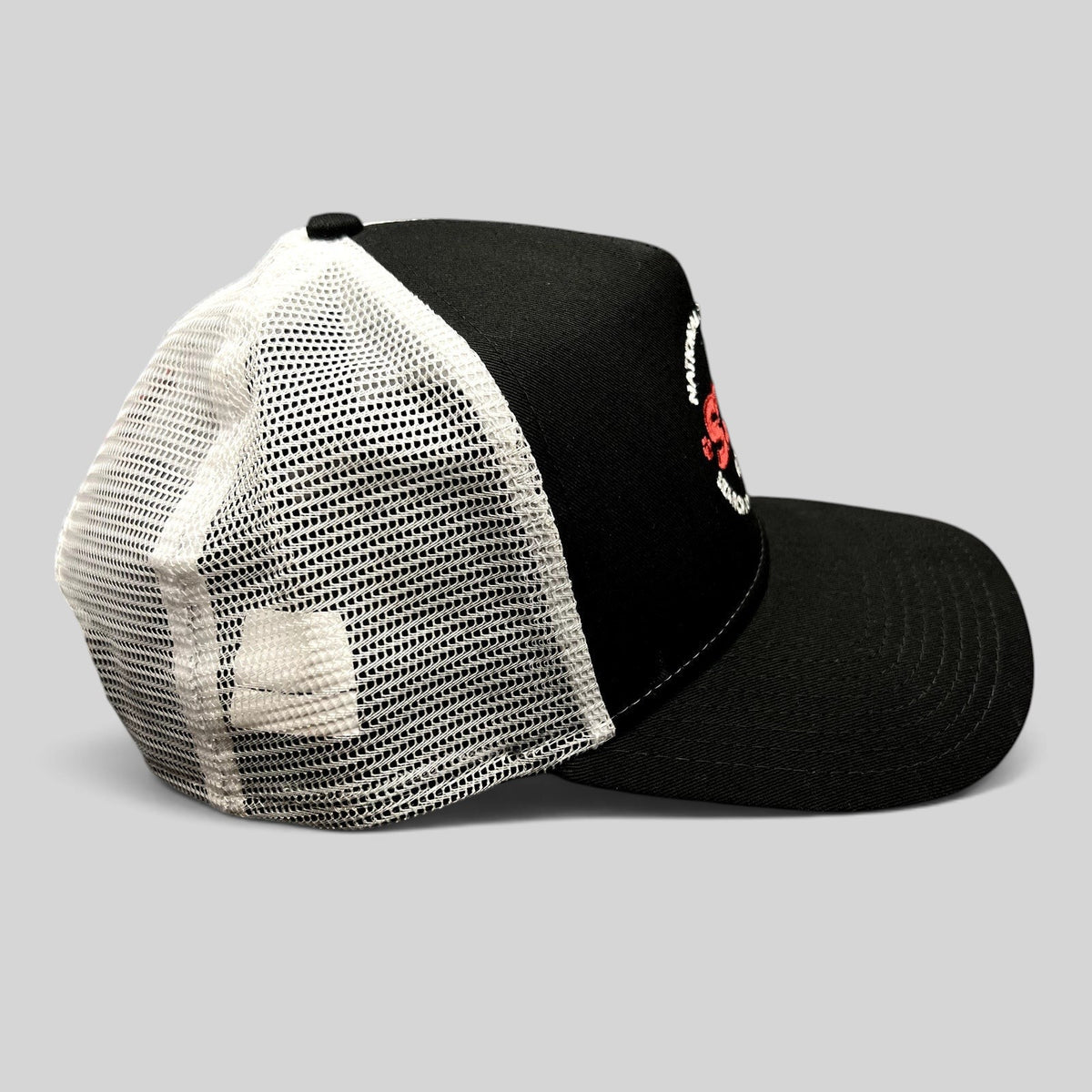 Raree Finds New Era 9FORTY SDF trucker hat with black front, white mesh back, and embroidered logo, side view.