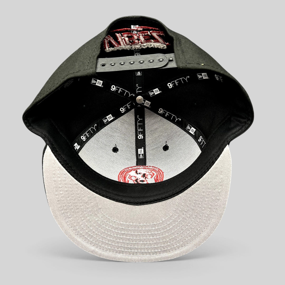 Raree Finds New Era 9FIFTY snapback hat in black with red embroidery, featuring an adjustable closure and flat bill.