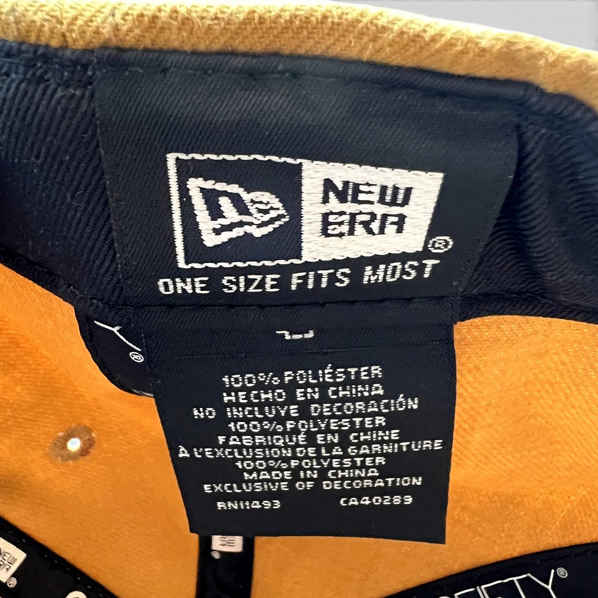 Raree Finds New Era 9FIFTY snapback interior label showing 100% polyester material and manufacturing details