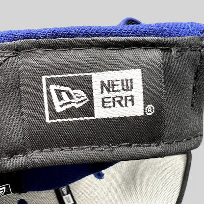Raree Finds New Era 9FIFTY snapback interior tag showing brand logo on a royal blue and black baseball cap