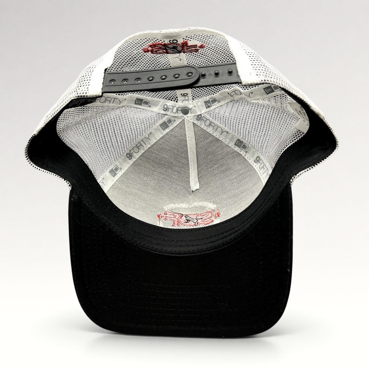 Raree Finds New Era 9FORTY trucker hat interior showing white mesh, black brim, and SDF logo embroidery