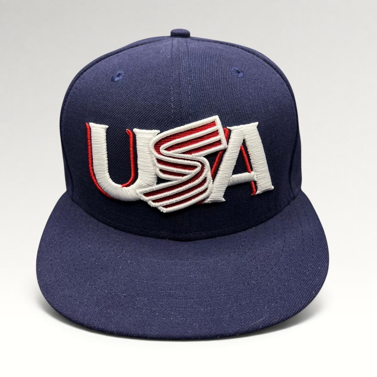 Raree Finds navy New Era 59FIFTY fitted hat with USA embroidery in red and white on the front structured crown.