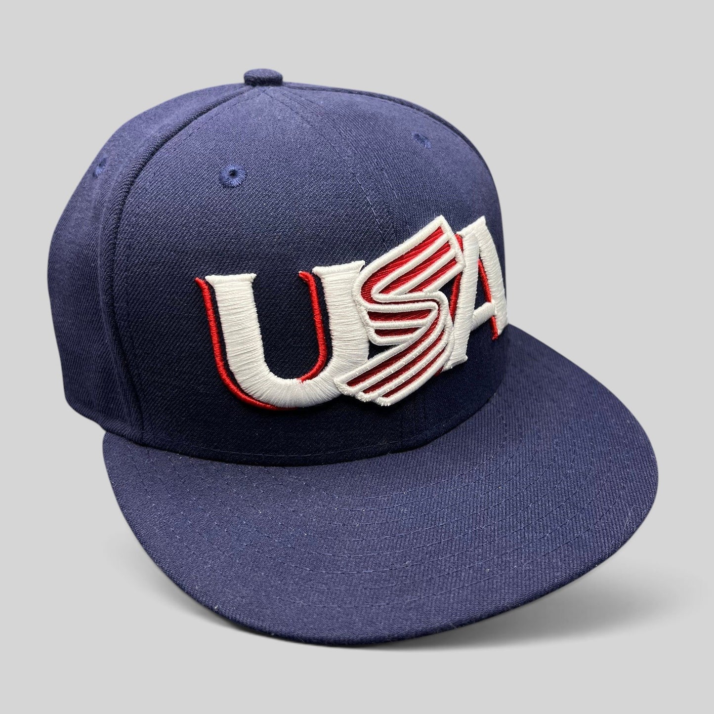 Raree Finds New Era 59FIFTY navy fitted hat with USA embroidery in red and white, featuring a flat brim design.