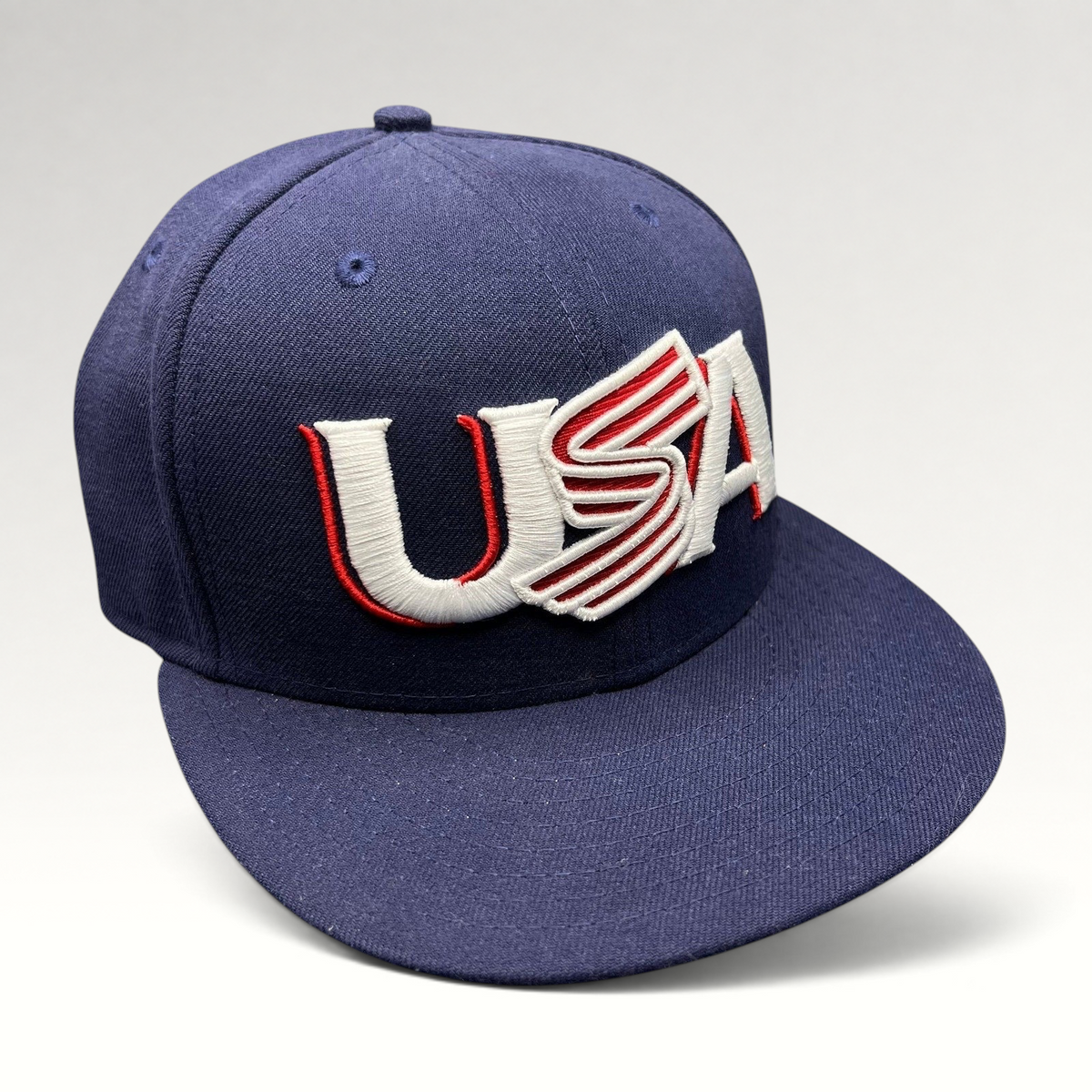 Raree Finds New Era 59FIFTY navy fitted hat with USA embroidery in red and white, featuring a flat brim design.